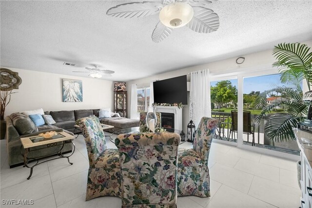 4251 Island Cir Unit 3, Fort Myers, FL 33919 - living area with a ceiling fan, healthy amount of natural light, a textured ceiling, and light tile patterned flooring