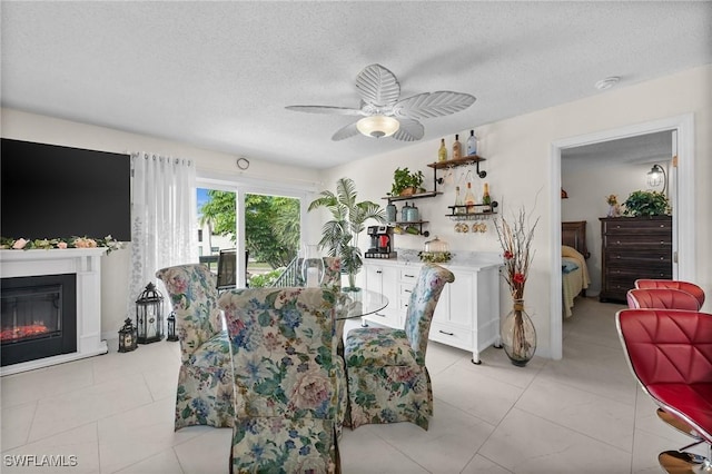 4251 Island Cir Unit 3, Fort Myers, FL 33919 - dining area with a ceiling fan, a textured ceiling, and a glass covered fireplace