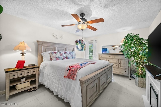 4251 Island Cir Unit 3, Fort Myers, FL 33919 - bedroom with ceiling fan, a textured ceiling, and light tile patterned flooring