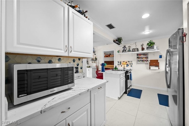 4251 Island Cir Unit 3, Fort Myers, FL 33919 - kitchen featuring stainless steel appliances, white cabinets, light stone counters, crown molding, and open shelves