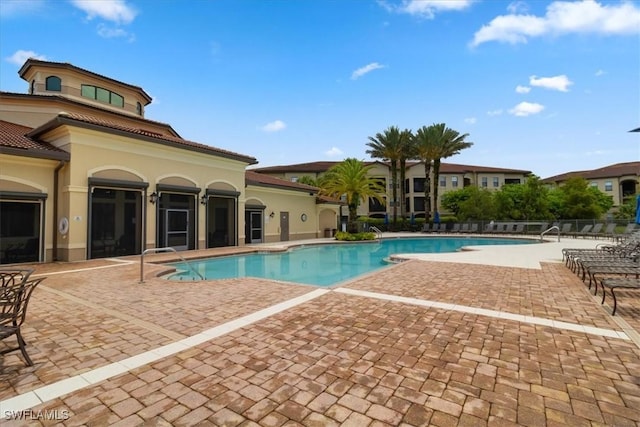 12970 Positano Cir Unit 301, Naples, FL 34105 - community pool featuring a patio area