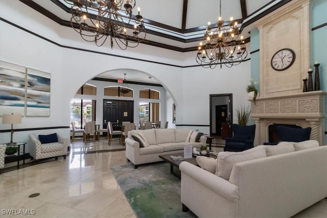 12970 Positano Cir Unit 301, Naples, FL 34105 - tiled living area featuring a chandelier, a high ceiling, arched walkways, and crown molding