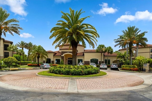 12970 Positano Cir Unit 301, Naples, FL 34105 - view of property featuring curved driveway
