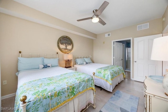 12970 Positano Cir Unit 301, Naples, FL 34105 - bedroom with light wood-type flooring and a ceiling fan