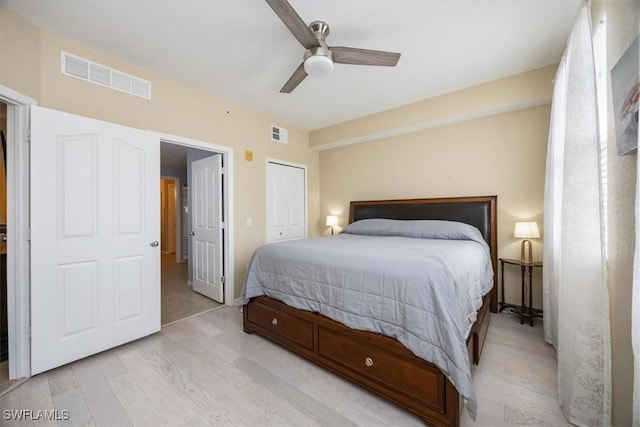 12970 Positano Cir Unit 301, Naples, FL 34105 - bedroom featuring wood finished floors, ceiling fan, and a closet
