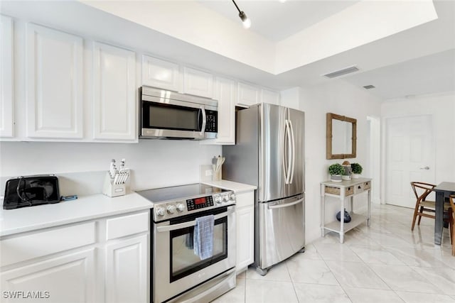 636 98th Ave N, Naples, FL 34108 - kitchen featuring appliances with stainless steel finishes, white cabinetry, and light marble finish floors