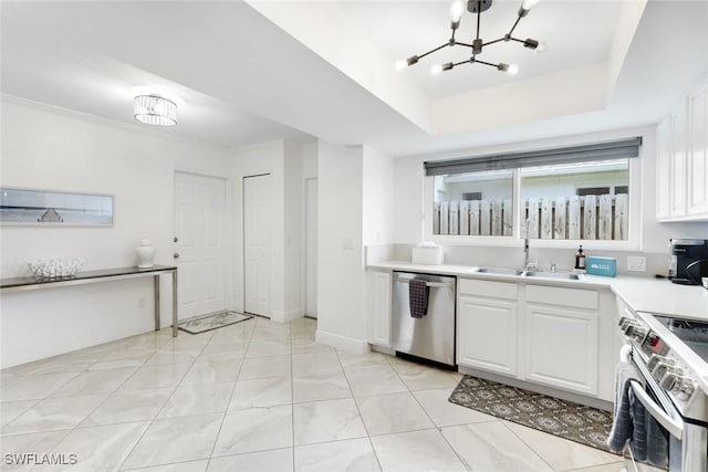 636 98th Ave N, Naples, FL 34108 - kitchen featuring appliances with stainless steel finishes, a chandelier, white cabinets, and light countertops
