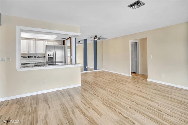 4210 SE 20th Pl Unit C2, Cape Coral, FL 33904 - unfurnished living room featuring light wood-style flooring and a ceiling fan