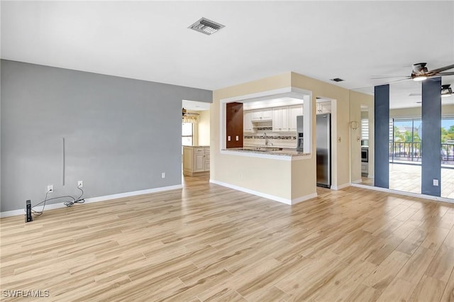 4210 SE 20th Pl Unit C2, Cape Coral, FL 33904 - unfurnished living room with light wood-style flooring and a ceiling fan