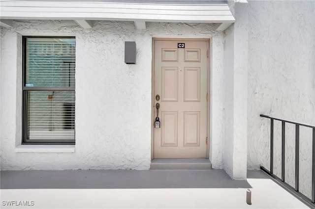 4210 SE 20th Pl Unit C2, Cape Coral, FL 33904 - doorway to property featuring stucco siding