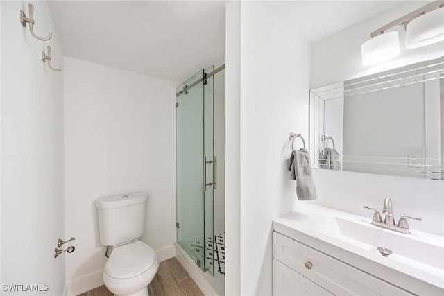 3070 Gulf Shore Blvd N Unit 104, Naples, FL 34103 - bathroom with vanity, a stall shower, and wood finished floors