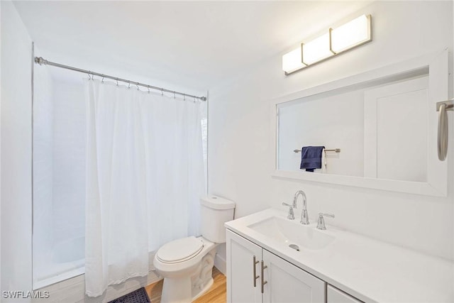 3070 Gulf Shore Blvd N Unit 104, Naples, FL 34103 - bathroom with vanity, wood finished floors, and shower / tub combo with curtain