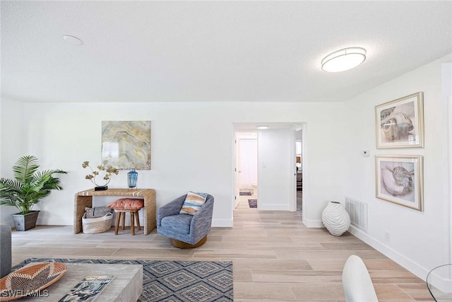 3070 Gulf Shore Blvd N Unit 104, Naples, FL 34103 - living area with light wood-style flooring and a textured ceiling