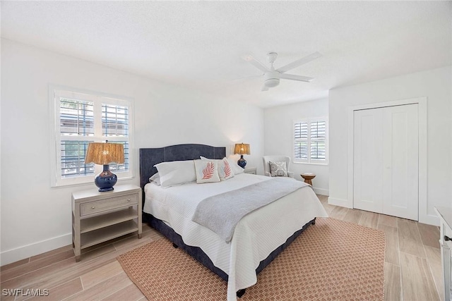3070 Gulf Shore Blvd N Unit 104, Naples, FL 34103 - bedroom featuring light wood-style flooring, ceiling fan, and a closet