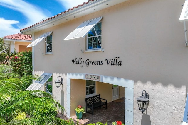 3070 Gulf Shore Blvd N Unit 104, Naples, FL 34103 - view of side of home with stucco siding and a tiled roof
