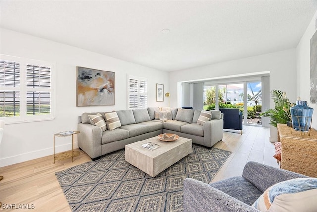 3070 Gulf Shore Blvd N Unit 104, Naples, FL 34103 - living room with healthy amount of natural light and wood finished floors