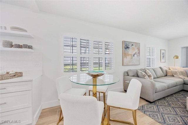 3070 Gulf Shore Blvd N Unit 104, Naples, FL 34103 - dining space with light wood-style floors and baseboards