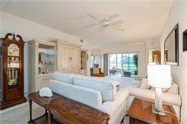 13221 Sherburne Cir Unit 601, Bonita Springs, FL 34135 - living room with light colored carpet and ceiling fan