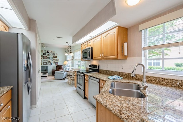 13221 Sherburne Cir Unit 601, Bonita Springs, FL 34135 - kitchen with stainless steel appliances, light stone countertops, light tile patterned floors, and tasteful backsplash