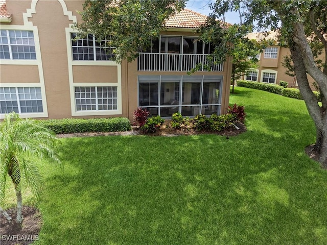 13221 Sherburne Cir Unit 601, Bonita Springs, FL 34135 - rear view of house with stucco siding, a lawn, and a tile roof