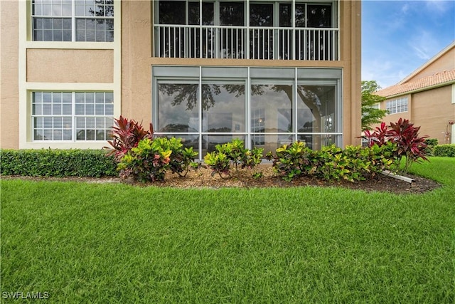 13221 Sherburne Cir Unit 601, Bonita Springs, FL 34135 - rear view of house featuring a yard and stucco siding
