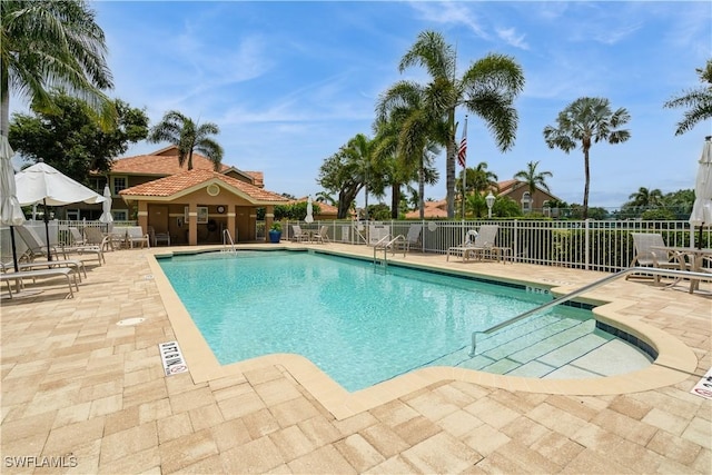 13221 Sherburne Cir Unit 601, Bonita Springs, FL 34135 - community pool featuring a patio
