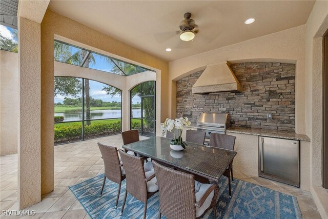 3441 Runaway Ln, Naples, FL 34114 - view of patio with exterior kitchen, a water view, ceiling fan, and outdoor dining space