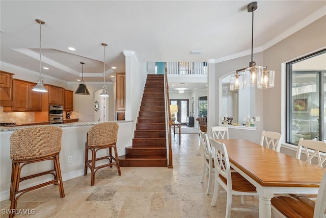 3441 Runaway Ln, Naples, FL 34114 - dining room featuring stone tile floors, ornamental molding, stairs, a tray ceiling, and recessed lighting