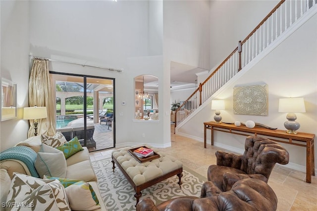 3441 Runaway Ln, Naples, FL 34114 - living room with arched walkways, a high ceiling, and stairway