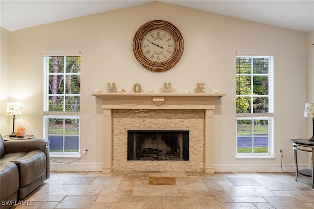 6011 Sea Grass Ln, Naples, FL 34116 - living area featuring stone tile flooring, vaulted ceiling, and a tile fireplace