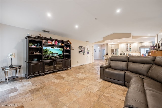 6011 Sea Grass Ln, Naples, FL 34116 - living room featuring stone tile floors, lofted ceiling, and recessed lighting
