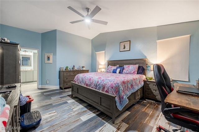 6011 Sea Grass Ln, Naples, FL 34116 - bedroom with wood finished floors, vaulted ceiling, an office area, ceiling fan, and connected bathroom