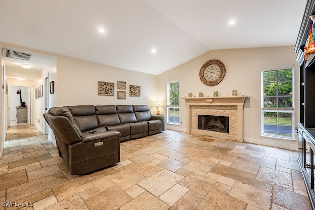 6011 Sea Grass Ln, Naples, FL 34116 - living area with stone tile floors, recessed lighting, lofted ceiling, and a tiled fireplace