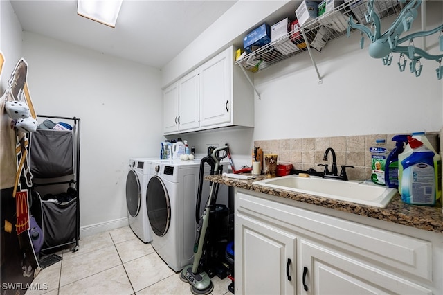 6011 Sea Grass Ln, Naples, FL 34116 - washroom with washing machine and dryer, cabinet space, and light tile patterned flooring
