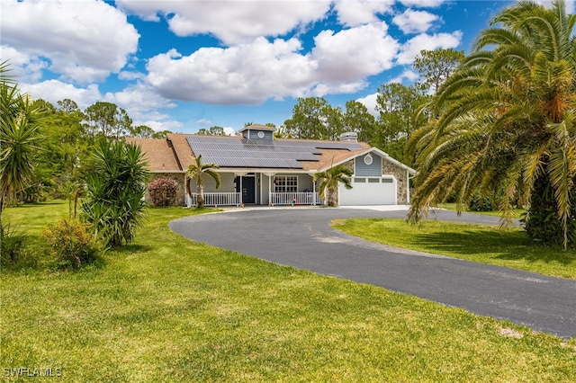 6011 Sea Grass Ln, Naples, FL 34116 - view of front of house featuring a porch, solar panels, driveway, a front yard, and an attached garage