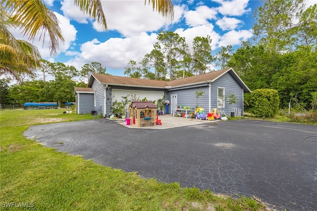 6011 Sea Grass Ln, Naples, FL 34116 - view of front of property featuring a front yard, driveway, and a garage