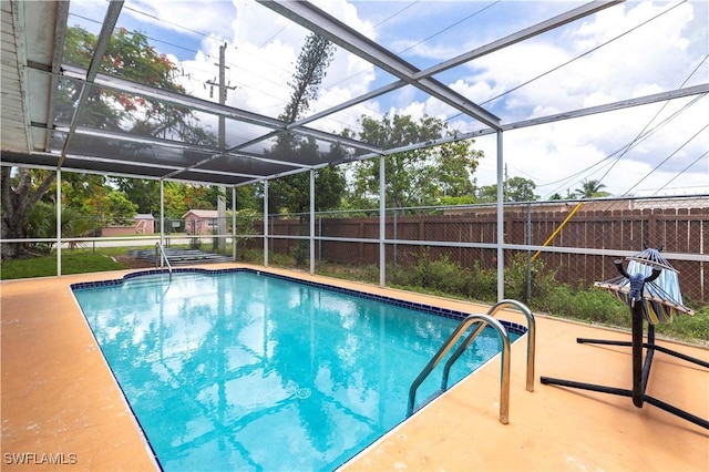 2401 Parkway St, Fort Myers, FL 33901 - view of swimming pool featuring a fenced backyard, glass enclosure, and a patio