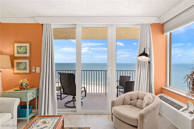 7360 Estero Blvd Unit Ph5, Fort Myers Beach, FL 33931 - living area with a water view, a textured ceiling, and ornamental molding