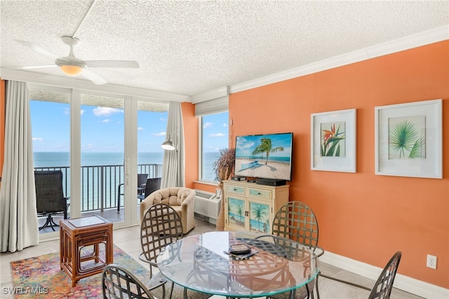 7360 Estero Blvd Unit Ph5, Fort Myers Beach, FL 33931 - tiled dining room with a textured ceiling, a ceiling fan, and ornamental molding
