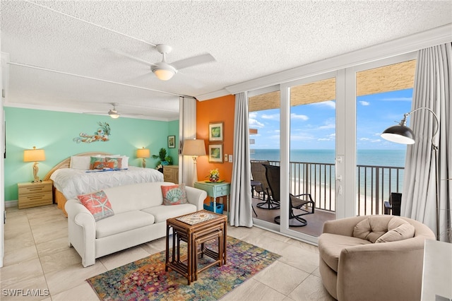 7360 Estero Blvd Unit Ph5, Fort Myers Beach, FL 33931 - bedroom with a water view, access to outside, expansive windows, a textured ceiling, and tile patterned floors