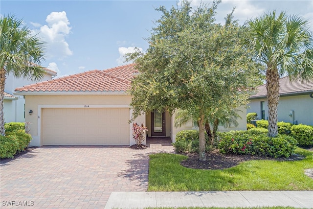 1964 Parson St, Naples, FL 34120 - view of front of property featuring a garage, stucco siding, decorative driveway, and a tile roof