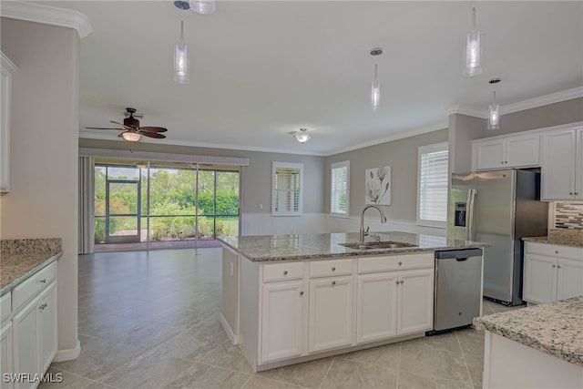 1964 Parson St, Naples, FL 34120 - kitchen featuring appliances with stainless steel finishes, ornamental molding, a ceiling fan, a center island with sink, and healthy amount of natural light