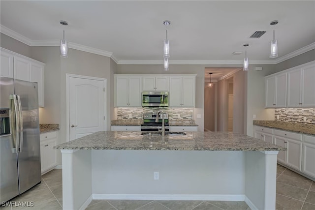 1964 Parson St, Naples, FL 34120 - kitchen featuring stainless steel appliances, tasteful backsplash, a kitchen island with sink, white cabinets, and crown molding