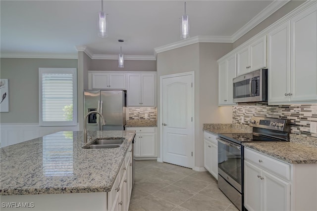 1964 Parson St, Naples, FL 34120 - kitchen featuring appliances with stainless steel finishes, white cabinetry, backsplash, hanging light fixtures, and ornamental molding