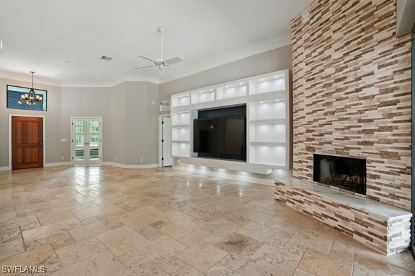 4740 5th Ave SW, Naples, FL 34119 - unfurnished living room with stone tile flooring, crown molding, a tiled fireplace, ceiling fan, and a chandelier