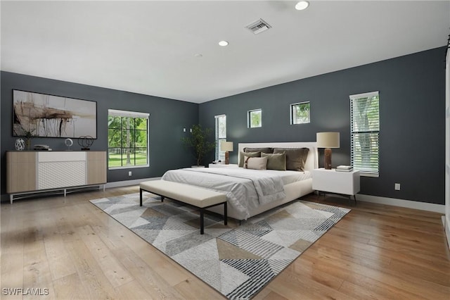4740 5th Ave SW, Naples, FL 34119 - bedroom featuring hardwood / wood-style flooring, multiple windows, and recessed lighting