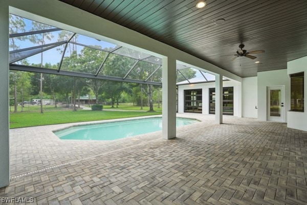 4740 5th Ave SW, Naples, FL 34119 - swimming pool featuring a patio area, a ceiling fan, a lawn, and a lanai