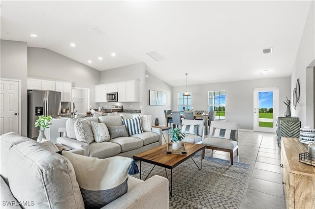 615 NW 25th Ter, Cape Coral, FL 33993 - living room with lofted ceiling, recessed lighting, and light tile patterned floors