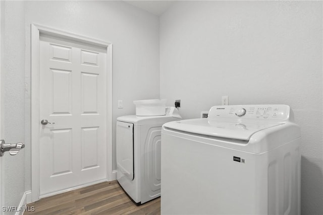 311 Long Ave S, Lehigh Acres, FL 33974 - washroom with washer and clothes dryer and dark wood finished floors