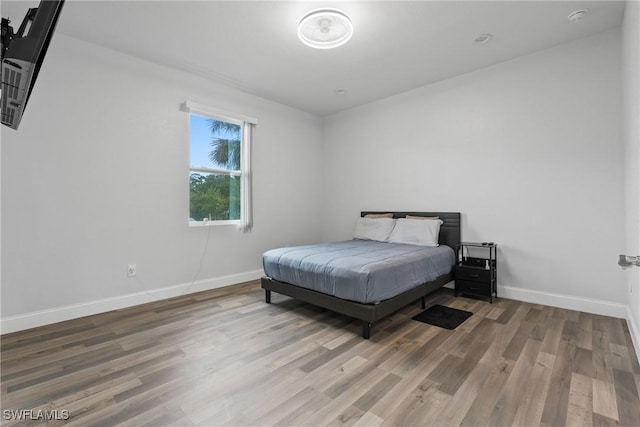 311 Long Ave S, Lehigh Acres, FL 33974 - bedroom featuring wood finished floors and baseboards